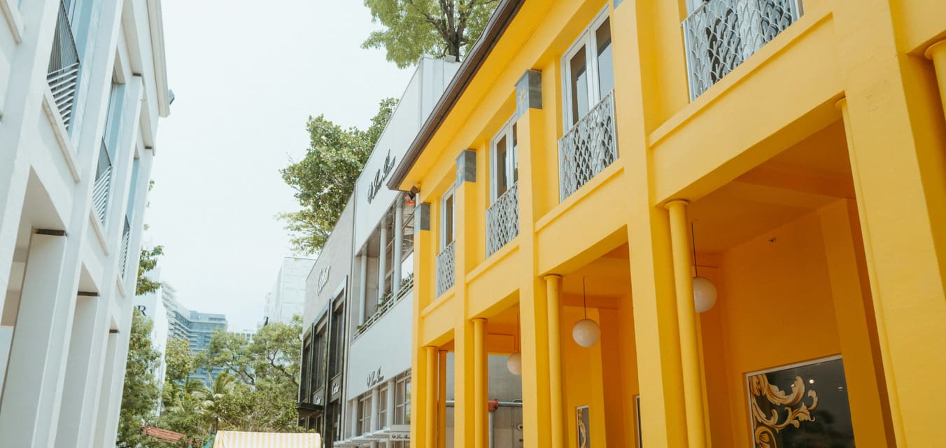Bright yellow commercial building on a Miami street