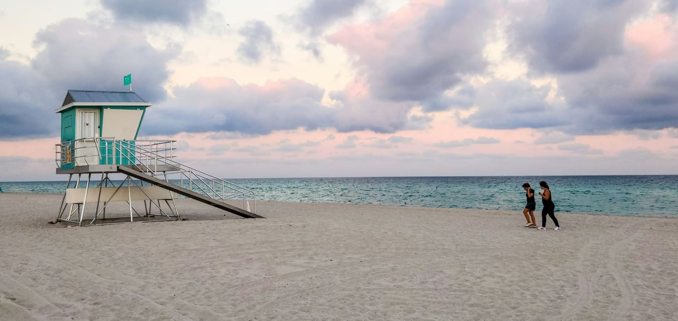 Lifeguard tower on a Miami beach under a cloudy evening sky