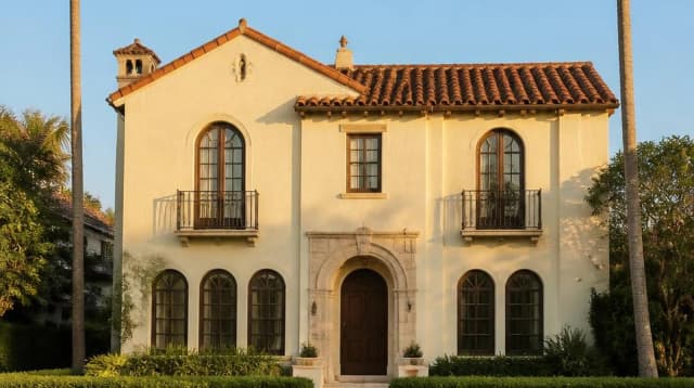 Una casa in stile Mediterranean Revival a Miami sotto un cielo sereno, nel tardo pomeriggio.